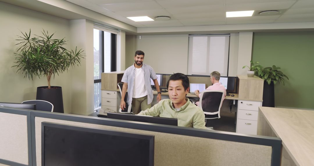 Diverse coworkers collaborating in a modern open plan office setting