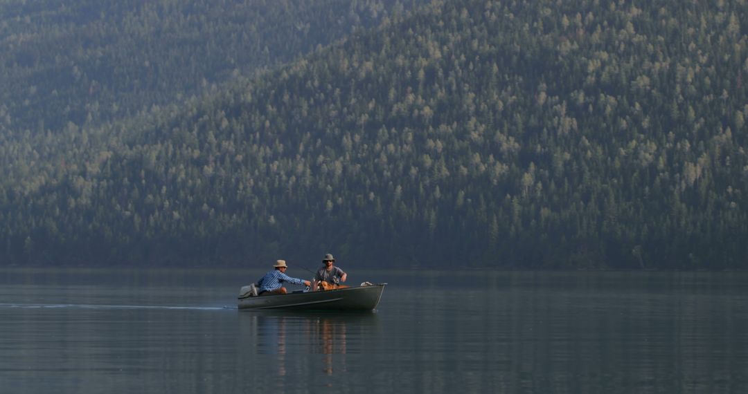 Two Men Fishing on Serene Mountain Lake at Sunset - Free Images, Stock Photos and Pictures on Pikwizard.com