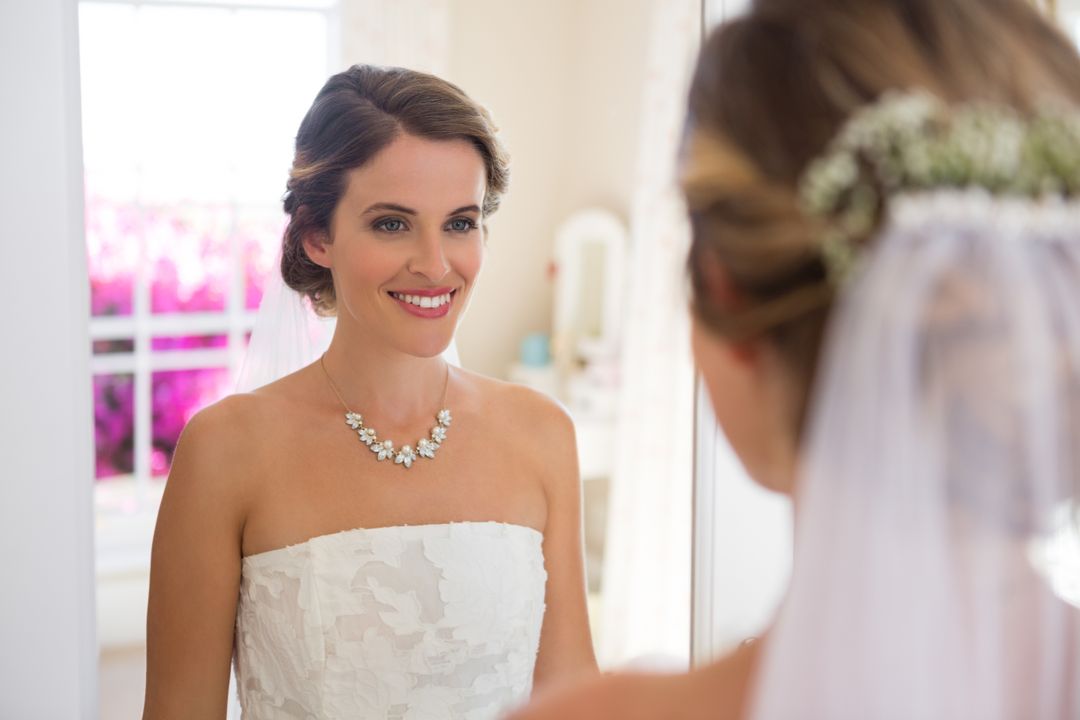 Beautiful Bride Smiling in Mirror on Wedding Day - Free Images, Stock Photos and Pictures on Pikwizard.com