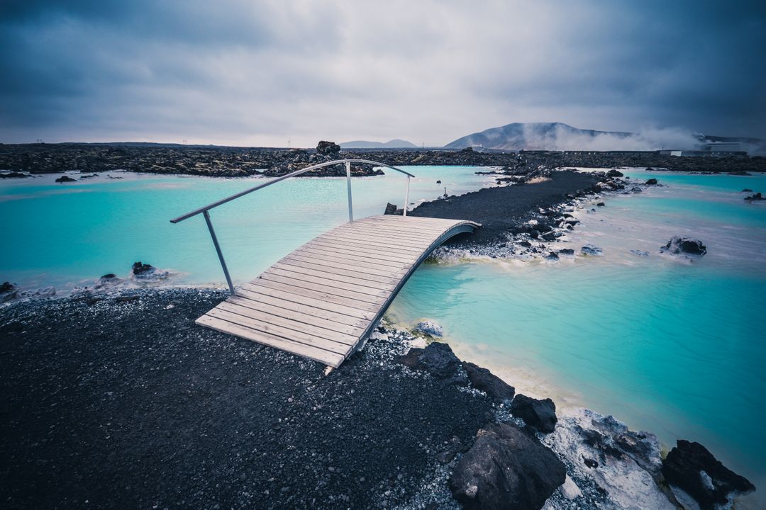 Scenic Wooden Bridge Over blue Thermal Waters in Geothermal Landscape - Free Images, Stock Photos and Pictures on Pikwizard.com
