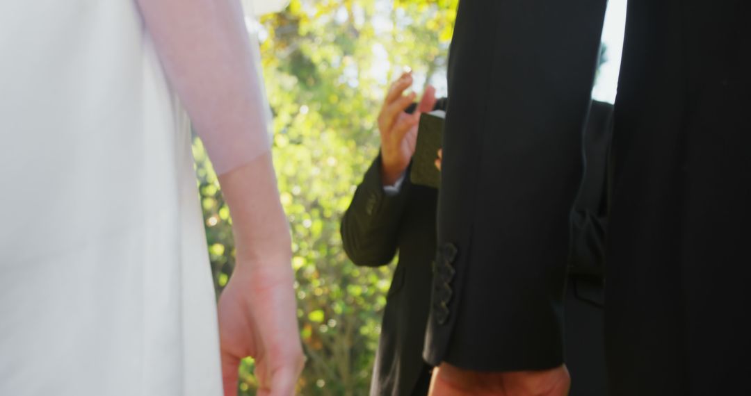 Close-Up of Bride and Groom Hand in Hand During Outdoor Wedding - Free Images, Stock Photos and Pictures on Pikwizard.com