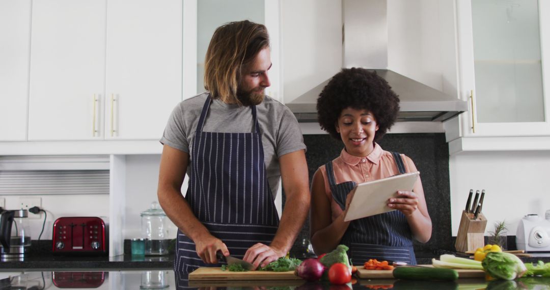 Couple Cooking in Kitchen Using Digital Tablet