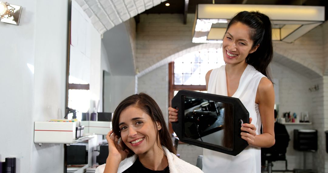 Hair Stylist Showing Mirror to Happy Client in Modern Salon - Free Images, Stock Photos and Pictures on Pikwizard.com