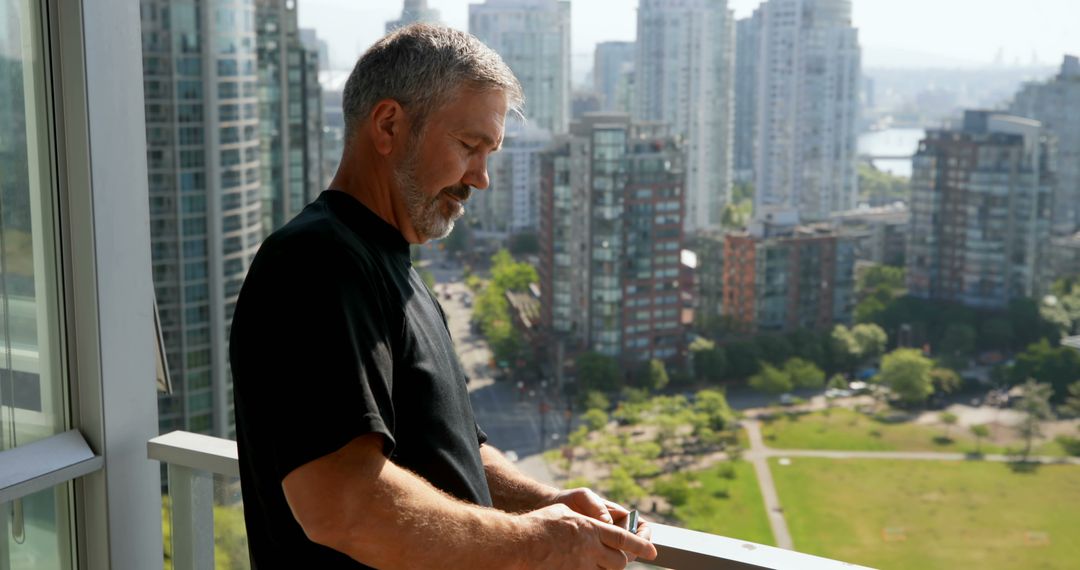 Man Reflecting on Balcony with City View at Sunset - Free Images, Stock Photos and Pictures on Pikwizard.com