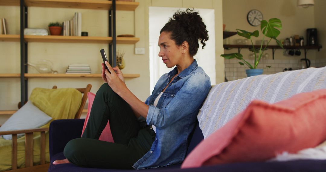 Woman Using Smartphone on Cozy Couch in Modern Living Room - Free Images, Stock Photos and Pictures on Pikwizard.com