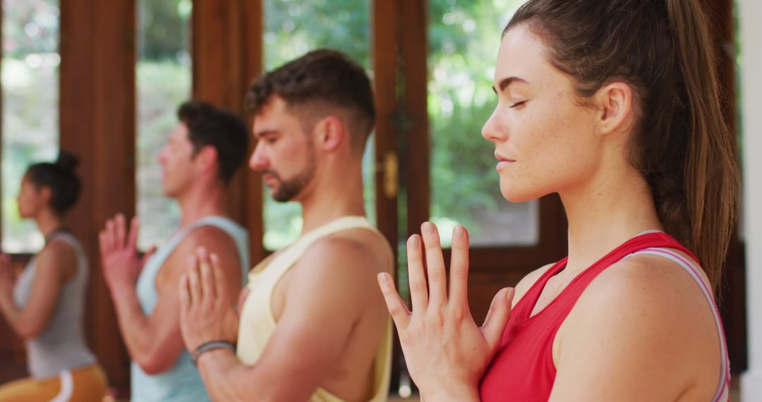 Diverse Group Engaged in Meditation Yoga Class with Eyes Closed