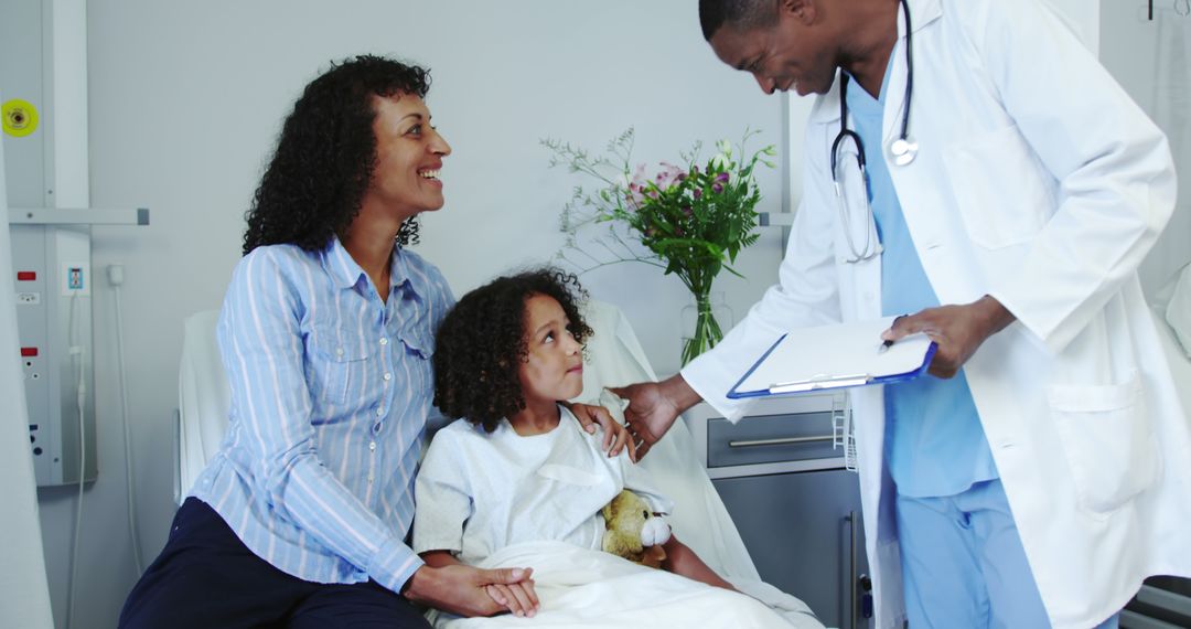 Doctor Talking to Mother and Daughter in Hospital Room - Free Images, Stock Photos and Pictures on Pikwizard.com