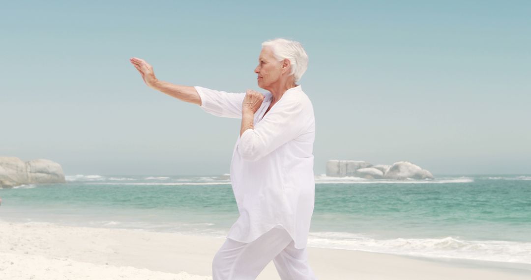 Senior Woman Practicing Tai Chi on Beach - Free Images, Stock Photos and Pictures on Pikwizard.com