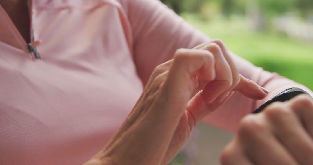 Person Using Smartwatch in Outdoor Setting - Free Images, Stock Photos and Pictures on Pikwizard.com