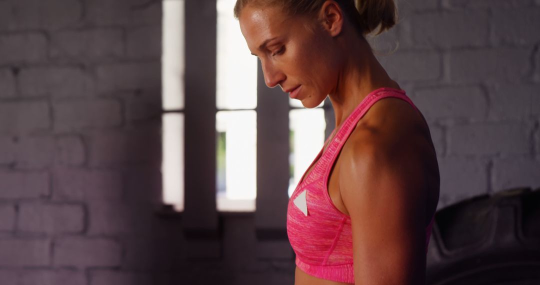 Focused Athlete in Pink Sports Bra Preparing for Workout - Free Images, Stock Photos and Pictures on Pikwizard.com