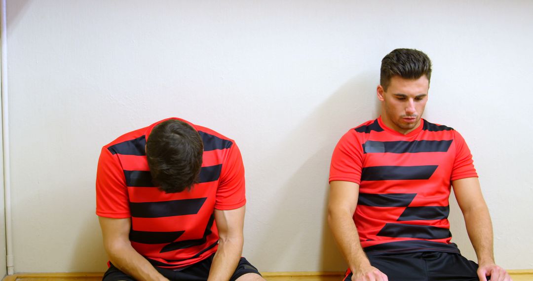 Two Soccer Players Sitting in Locker Room after Game - Free Images, Stock Photos and Pictures on Pikwizard.com