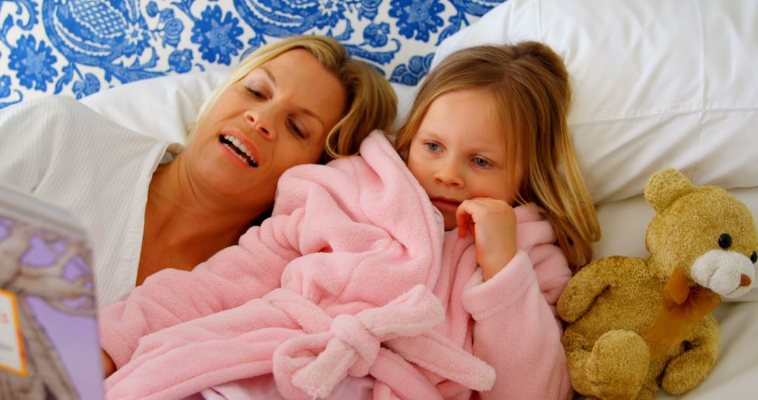 Mother Reading Bedtime Story to Daughter in Bed - Free Images, Stock Photos and Pictures on Pikwizard.com