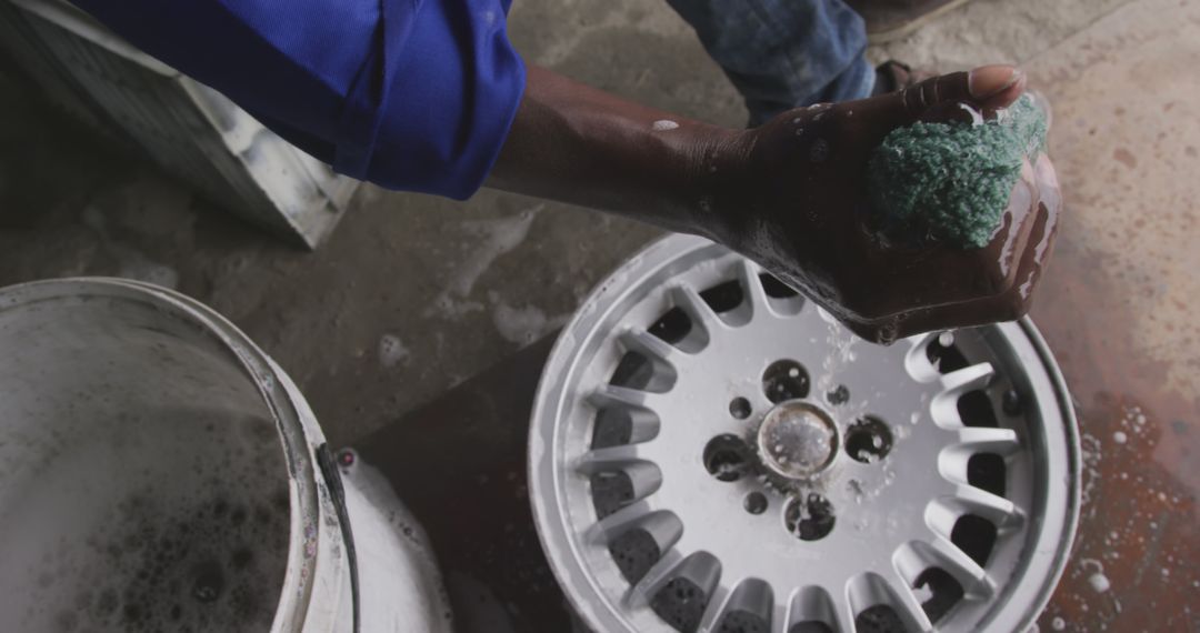 Close-up of Person Cleaning Car Tire Rim with Sponge - Free Images, Stock Photos and Pictures on Pikwizard.com