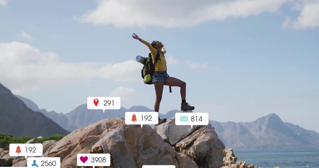 Hiker Raising Arms Overhead on Scenic Coastal Rock with Overlay Notification Icons