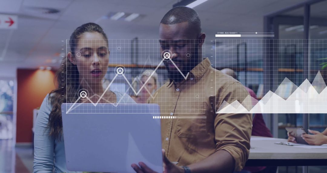 Colleagues Analysing Financial Data in Modern Office