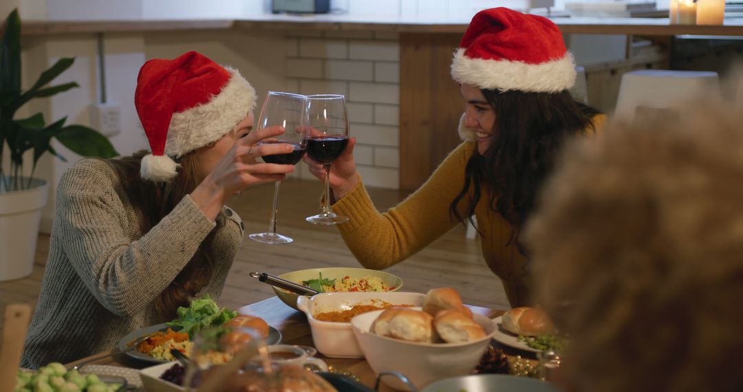 Friends Toasting During Festive Holiday Dinner Celebration - Free Images, Stock Photos and Pictures on Pikwizard.com