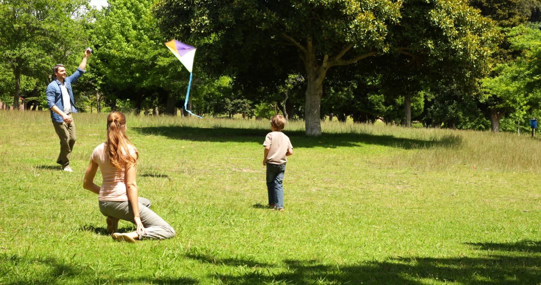 Family Enjoying Kite Flying Activity in Sunny Park - Free Images, Stock Photos and Pictures on Pikwizard.com