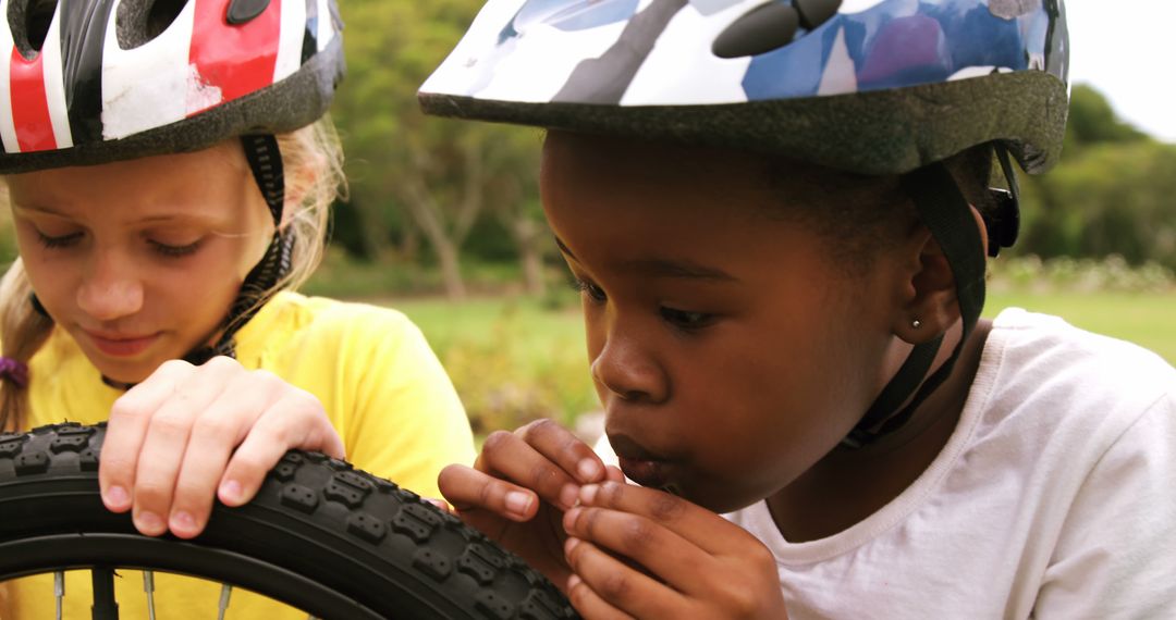 Two Girls Fixing Bike Tire with Helmets in Park - Free Images, Stock Photos and Pictures on Pikwizard.com