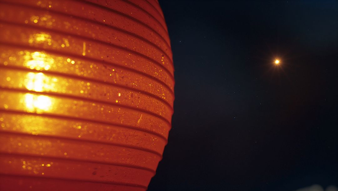 Glowing Red Paper Lantern with Star-like Light at Night