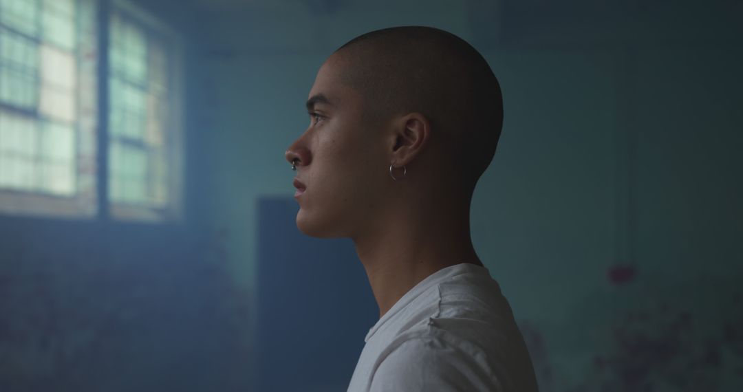 Contemplative Young Man in Dimly Lit Room