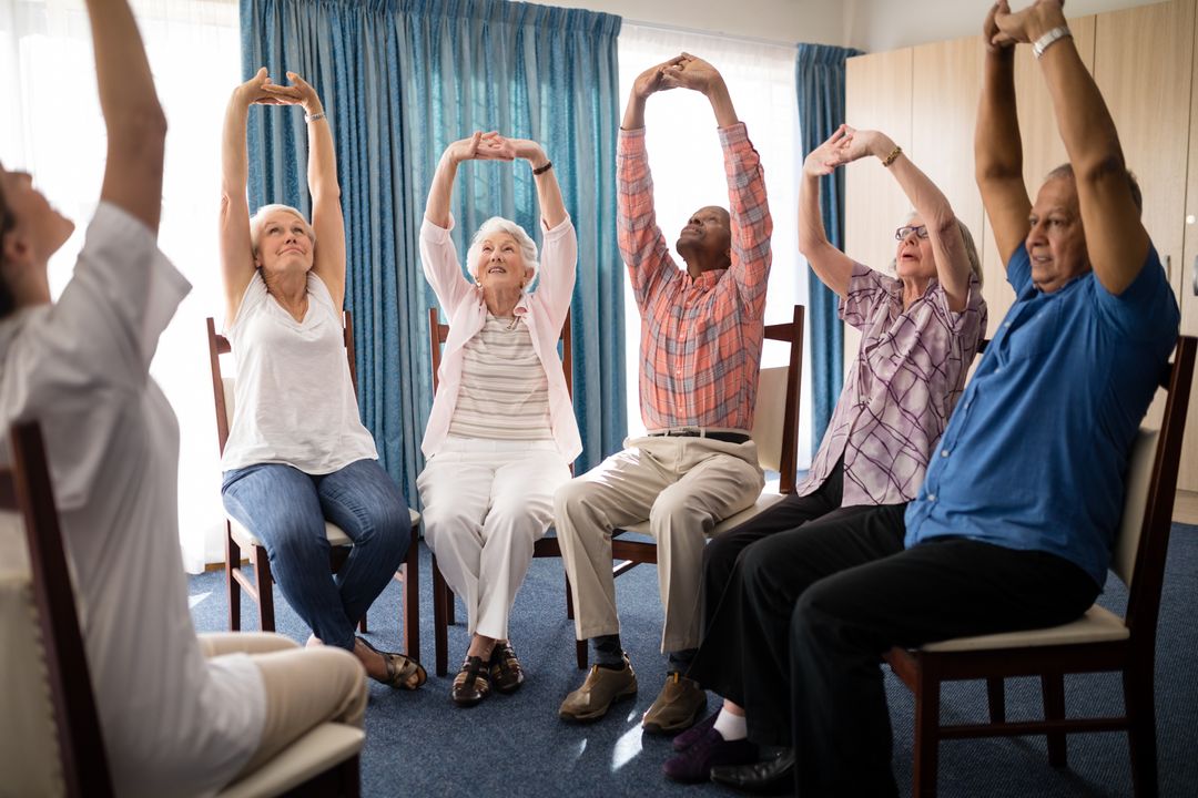 Seniors stretching with female doctor while sitting on chairs - Free Images, Stock Photos and Pictures on Pikwizard.com