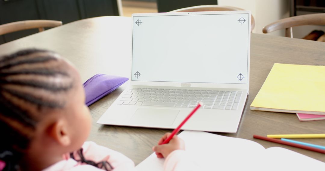 Young Girl in Online Class with White Laptop Screen