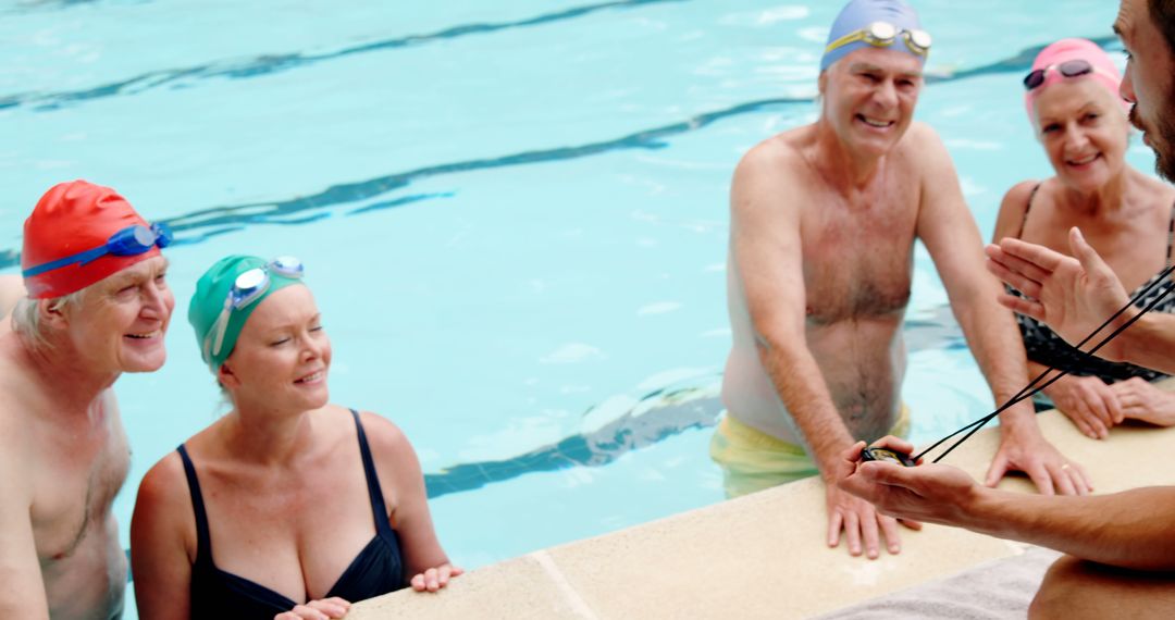 Senior Swimmers Engaging with Instructor in Pool Training Session - Free Images, Stock Photos and Pictures on Pikwizard.com