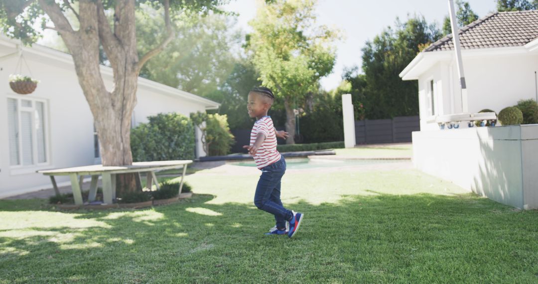 Young Boy Running Outdoors in a Sunny Yard - Free Images, Stock Photos and Pictures on Pikwizard.com