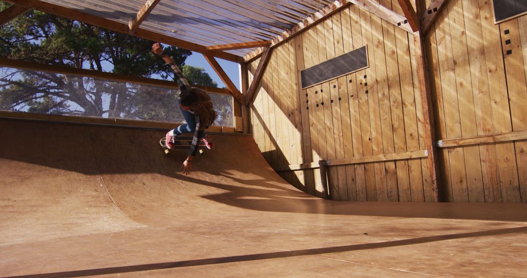 Skateboarder Performing Trick in Indoor Wooden Skate Park - Free Images, Stock Photos and Pictures on Pikwizard.com