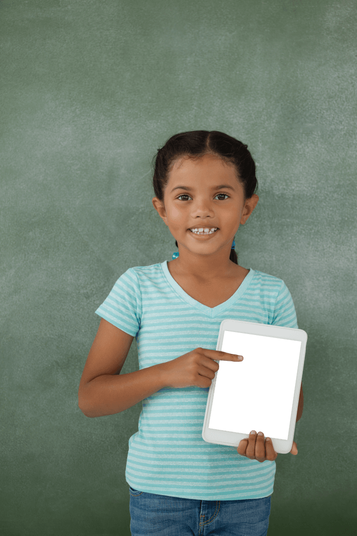 Smiling Girl Holding Transparent Screen Tablet Against Classroom Chalk Board