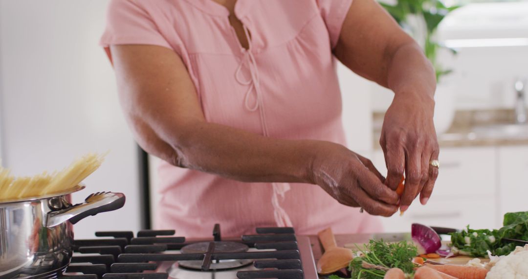 Senior Woman Cooking in Modern Kitchen - Free Images, Stock Photos and Pictures on Pikwizard.com