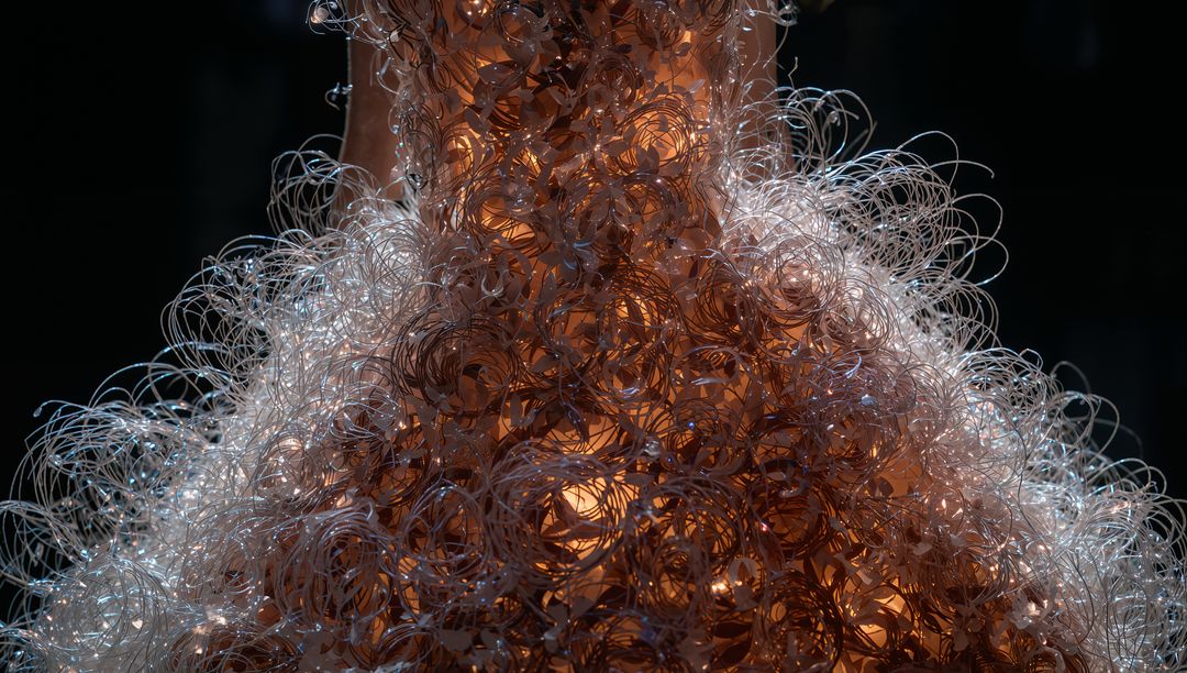 Glowing Conical Filament Sculpture Emitting Amber Light with Translucent Spiral Weave