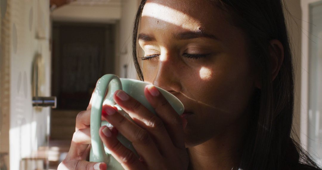 Woman Savoring Warm Beverage in Sunlit Room - Free Images, Stock Photos and Pictures on Pikwizard.com