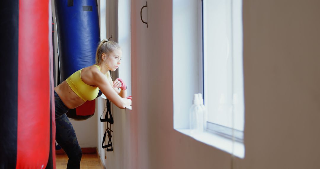 Young woman training with punching bags in gym - Free Images, Stock Photos and Pictures on Pikwizard.com