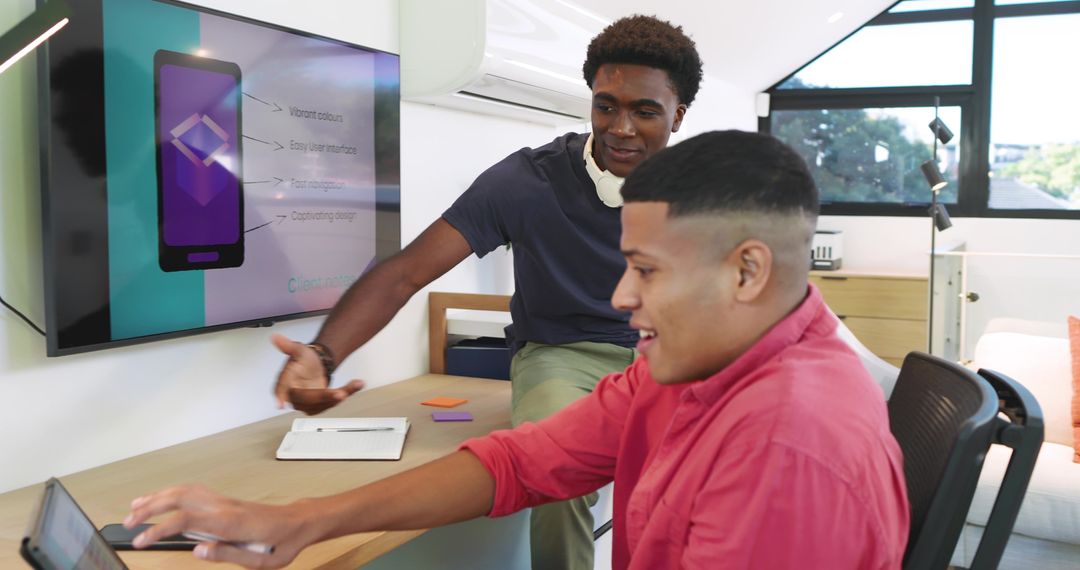 Diverse Team Collaborating on Mobile App Development in Modern Office