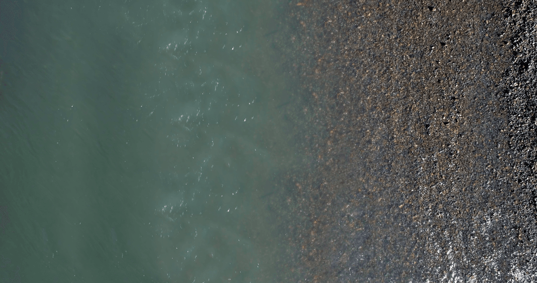 Aerial View of Transparent Lakeshore with Pebbled Texture