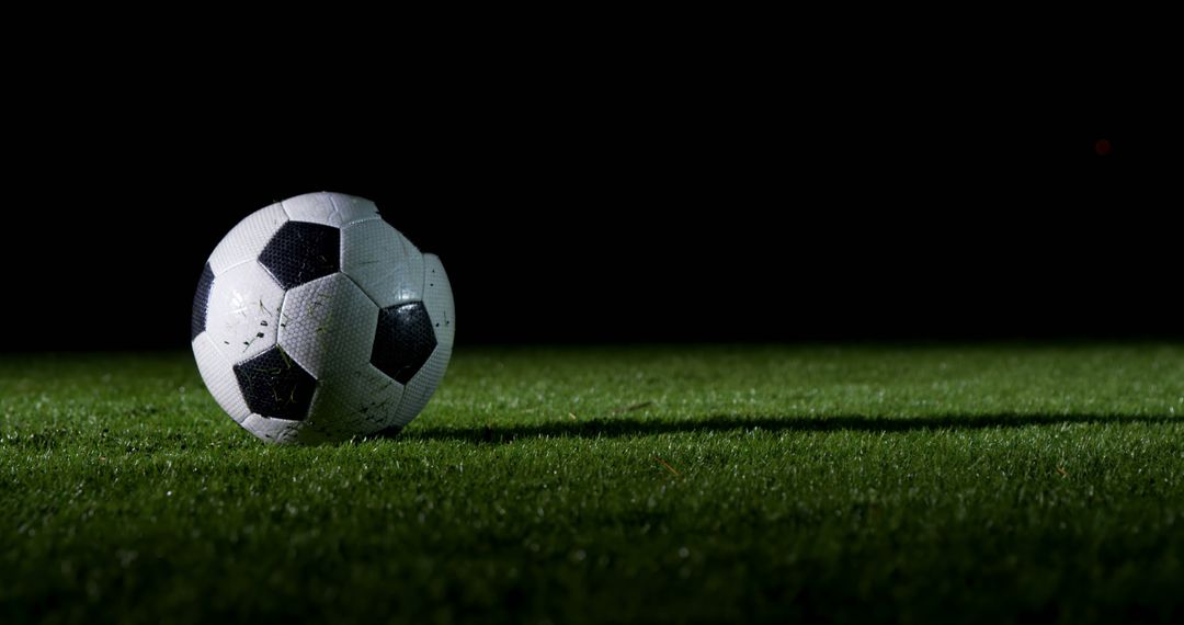 Lonely Soccer Ball on Green Grass Under Spotlight at Night - Free Images, Stock Photos and Pictures on Pikwizard.com