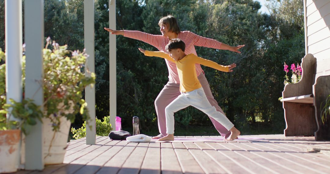 Grandmother and Grandson Practicing Yoga on Terrace - Free Images, Stock Photos and Pictures on Pikwizard.com