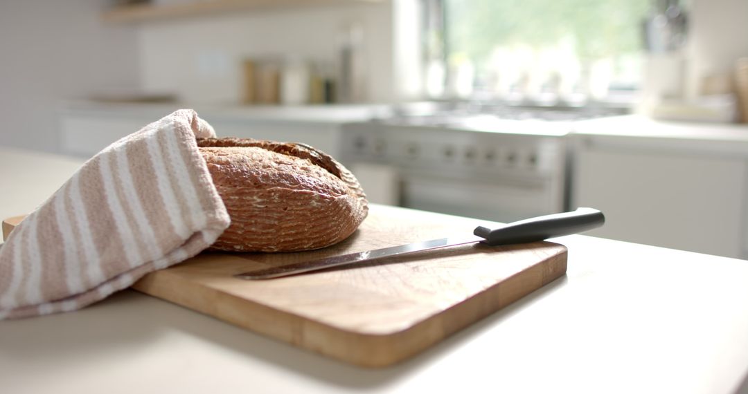 Sunlit Kitchen with Freshly Baked Bread on Cutting Board