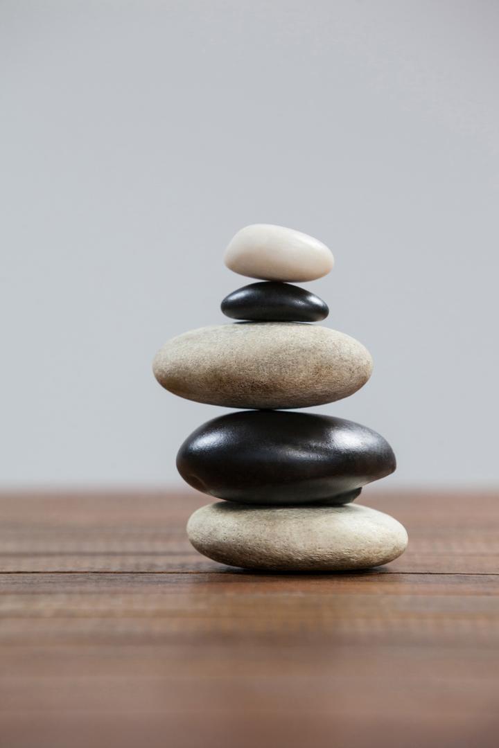 Balanced Stack of Pebble Stones on Wooden Surface - Free Images, Stock Photos and Pictures on Pikwizard.com