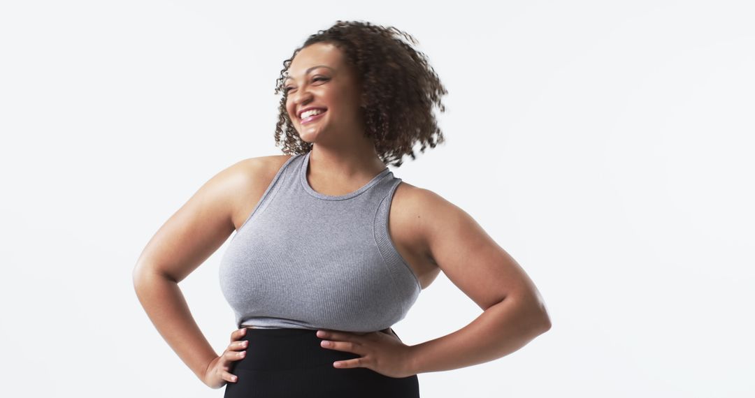 Confident Plus-Size Woman Smiling with Hands on Hips