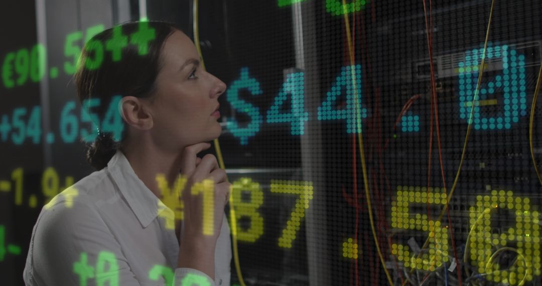 Data Engineer Examining Servers with Overlayed Financial Data