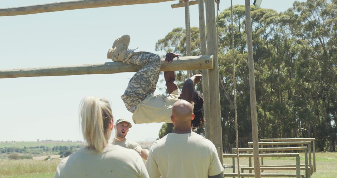 Soldier Mastering Obstacle Course with Team Support