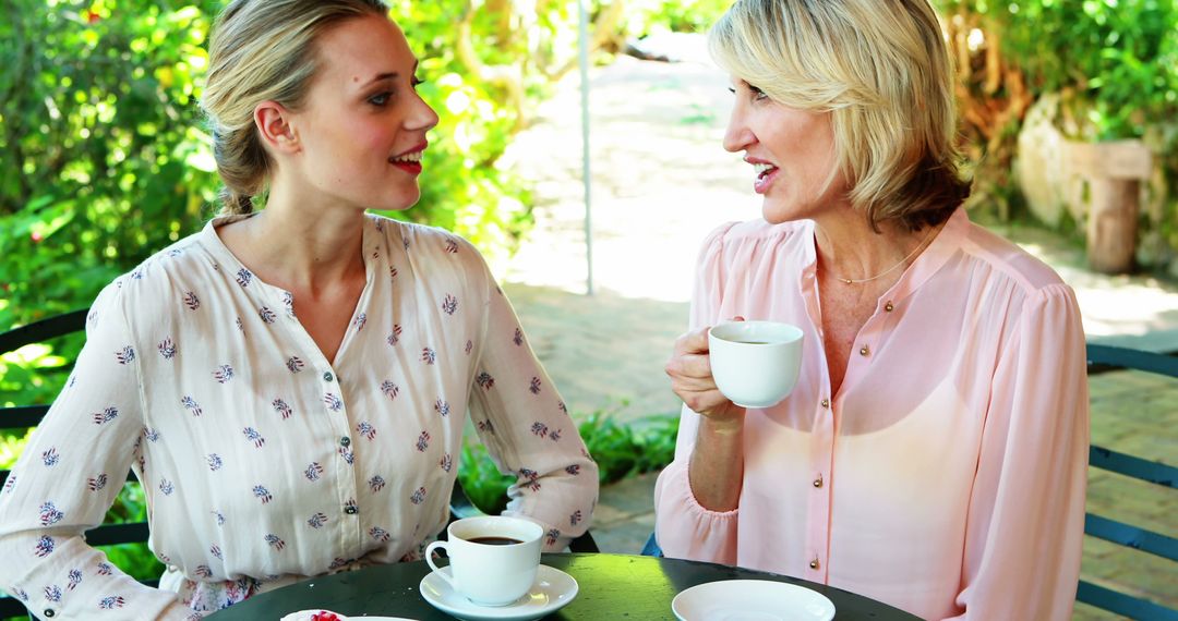 Mother and Daughter Enjoying Coffee and Conversation in Garden