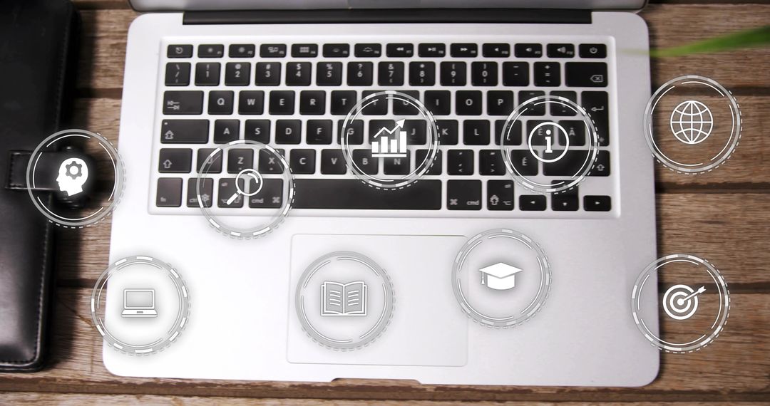 Silver Laptop on Wooden Desk Displaying Floating HUD Icons for Productivity and E-Learning