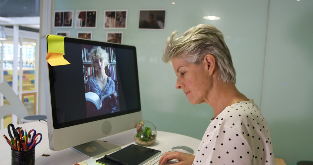 Older Woman Working on Computer in Modern Office - Free Images, Stock Photos and Pictures on Pikwizard.com