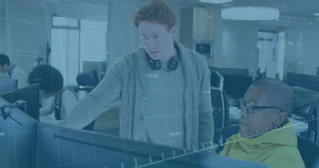 Developers Collaborating Over Computer Screens in Open Plan Office