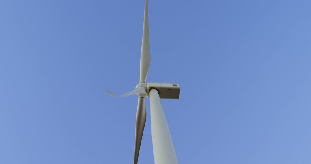 Low Angle View of Single Wind Turbine Against Clear Blue Sky - Free Images, Stock Photos and Pictures on Pikwizard.com