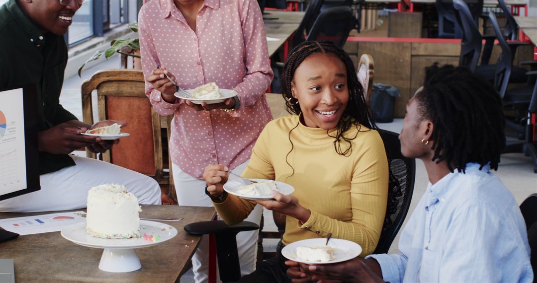Colleagues Enjoying Cake and Discussion During Office Break