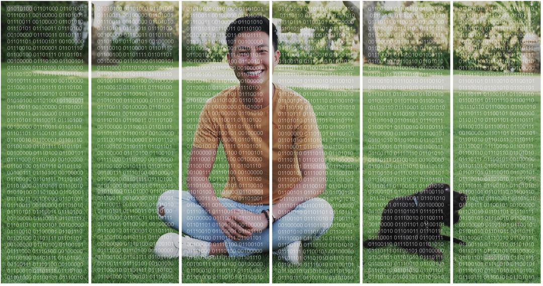 Smiling man sitting on grass using smartphone with backpack and camping lantern nearby